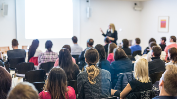 Woman Giving Presentation on Business Conference Workshop.